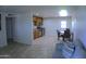 Bright living room featuring tile floors, neutral walls, and a dining area adjacent to an updated kitchen at 6725 W Cypress St, Phoenix, AZ 85035
