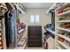 Walk-in closet with ample storage, including shelves, rods, and built-in dresser at 7469 E Timberlane Ct, Scottsdale, AZ 85258