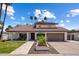 Charming home featuring a well-manicured lawn, desert landscaping, tile roof, and a spacious two-car garage at 7469 E Timberlane Ct, Scottsdale, AZ 85258