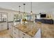 Gourmet kitchen with granite countertops, pendant lighting, and stainless-steel appliances, ideal for cooking at 7469 E Timberlane Ct, Scottsdale, AZ 85258