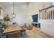 Living room with a high ceiling, stylish furniture, and a wall-mounted television at 7469 E Timberlane Ct, Scottsdale, AZ 85258