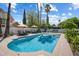 Sparkling pool with lounge chairs, umbrellas, and lush landscaping perfect for relaxation at 7469 E Timberlane Ct, Scottsdale, AZ 85258