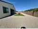 Backyard featuring gravel, turf, and outdoor dining area; ideal for entertaining at 8024 W State Ave, Glendale, AZ 85303
