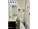 Updated bathroom featuring sink, toilet, mirror and tub with white tile at 8024 W State Ave, Glendale, AZ 85303