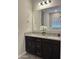Bathroom featuring double sinks, granite countertops, and stylish fixtures at 8024 W State Ave, Glendale, AZ 85303