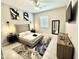 Modern bedroom features stylish decor, including a ceiling fan, unique artwork, and a sleek dresser at 8024 W State Ave, Glendale, AZ 85303