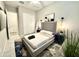Serene bedroom with plush bedding, modern lighting, ceiling fan, and convenient closet access at 8024 W State Ave, Glendale, AZ 85303