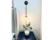 Bedside table with decorative lamp and elegant floral arrangement adds a touch of style to the bedroom at 8024 W State Ave, Glendale, AZ 85303