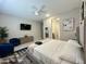 Comfortable bedroom featuring a large bed, soft linens, and a cozy seating area at 8024 W State Ave, Glendale, AZ 85303