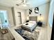Bright bedroom with a ceiling fan, closet, large windows and stylish decor at 8024 W State Ave, Glendale, AZ 85303