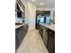 Stylish kitchen with stainless steel appliances, gray cabinets, tile backsplash, and granite countertops at 8024 W State Ave, Glendale, AZ 85303