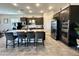 Modern kitchen with granite countertops, stainless steel appliances, dark cabinetry, and central island at 8024 W State Ave, Glendale, AZ 85303
