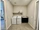 Functional laundry room features a washer, dryer, sink, cabinet, and storage shelf at 8024 W State Ave, Glendale, AZ 85303