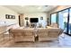 Spacious living room with modern wicker furniture, neutral colors, and ample natural light at 8024 W State Ave, Glendale, AZ 85303