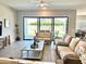 Living room with tile floors, modern furniture, and sliding glass doors leading to a backyard view at 8024 W State Ave, Glendale, AZ 85303