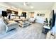 Bright living room features tile floors, modern furnishings, and connects seamlessly to the kitchen area at 8024 W State Ave, Glendale, AZ 85303