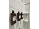 Updated Shower with soap and shampoo dispensers and white-tiled wall at 8024 W State Ave, Glendale, AZ 85303