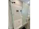 Modern walk-in shower with glass enclosure and white subway tile at 8024 W State Ave, Glendale, AZ 85303