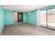 Spacious basement featuring tile floors, bright teal walls, and access to pool area at 9227 N 36Th Dr, Phoenix, AZ 85051
