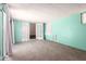 Spacious basement featuring tile floors, bright teal walls, and access to outdoors at 9227 N 36Th Dr, Phoenix, AZ 85051