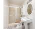 Bathroom featuring tiled shower, pedestal sink, and oval mirror at 9227 N 36Th Dr, Phoenix, AZ 85051