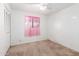 Bedroom with pink sheer curtains and closet with louvered doors at 9227 N 36Th Dr, Phoenix, AZ 85051