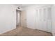 Bedroom with closet, neutral carpet, and doorway to hallway at 9227 N 36Th Dr, Phoenix, AZ 85051