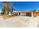 Exterior view of a single-story home with a carport and desert landscaping at 9227 N 36Th Dr, Phoenix, AZ 85051