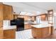 Traditional kitchen featuring wood cabinets, white counters, black appliances, and tiled floors at 9227 N 36Th Dr, Phoenix, AZ 85051