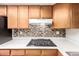 Contemporary kitchen with mosaic backsplash and gas cooktop on white countertops at 9227 N 36Th Dr, Phoenix, AZ 85051