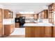 Kitchen featuring wood cabinets, black appliances, and white countertops at 9227 N 36Th Dr, Phoenix, AZ 85051