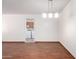 Open living area showcasing laminate floors and a three-light chandelier at 9227 N 36Th Dr, Phoenix, AZ 85051