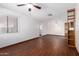 Open living room featuring laminate floors, ceiling fan, and good natural light at 9227 N 36Th Dr, Phoenix, AZ 85051