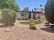 Private backyard featuring a patio, artificial turf, mature landscaping, and desert vegetation at 9406 S 47Th Pl, Phoenix, AZ 85044