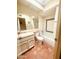 Well-lit bathroom featuring a tiled shower and terracotta flooring at 9406 S 47Th Pl, Phoenix, AZ 85044