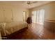 Cozy bedroom featuring tile flooring, a ceiling fan, and access to natural light at 9406 S 47Th Pl, Phoenix, AZ 85044