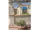 Charming front exterior with brick accents, blue awning, and mature landscaping at 9406 S 47Th Pl, Phoenix, AZ 85044