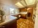 Well-lit kitchen with tile flooring, ample counter space, and wooden cabinets at 9406 S 47Th Pl, Phoenix, AZ 85044