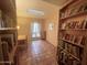 Inviting library space featuring terracotta floors, a bright skylight, and custom bookshelves at 9406 S 47Th Pl, Phoenix, AZ 85044