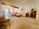 Spacious living room featuring neutral carpet, exposed beam, and plenty of natural light at 9406 S 47Th Pl, Phoenix, AZ 85044