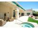 Back patio with hot tub and comfortable seating overlooking the well-maintained yard at 10800 E Cactus Rd # 34, Scottsdale, AZ 85259