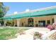 Covered back patio with awning, stylish outdoor furniture, and lush greenery at 10800 E Cactus Rd # 34, Scottsdale, AZ 85259