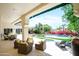 Inviting back patio with comfortable seating and view of a pool and manicured yard at 10800 E Cactus Rd # 34, Scottsdale, AZ 85259
