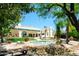 Serene backyard with mature trees, a sparkling pool, and manicured landscaping at 10800 E Cactus Rd # 34, Scottsdale, AZ 85259