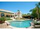 Expansive backyard with a sparkling pool, lush lawn, and desert-friendly landscaping at 10800 E Cactus Rd # 34, Scottsdale, AZ 85259