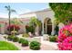 Inviting front entrance features stone landscaping, blooming bougainvillea, and cozy chairs at 10800 E Cactus Rd # 34, Scottsdale, AZ 85259