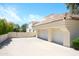 Spacious home featuring an attached two-car garage and a large concrete driveway at 10800 E Cactus Rd # 34, Scottsdale, AZ 85259