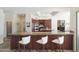Kitchen with a granite countertop island, breakfast bar, and wood cabinets at 10800 E Cactus Rd # 34, Scottsdale, AZ 85259
