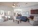 Open-concept living room with a wet bar and a view to the patio, perfect for relaxation and socializing at 10800 E Cactus Rd # 34, Scottsdale, AZ 85259