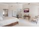 Bright main bedroom with a sitting area, ceiling fan, and large doorway at 10800 E Cactus Rd # 34, Scottsdale, AZ 85259
